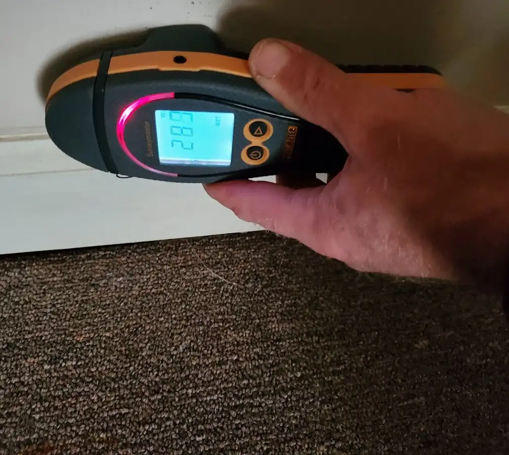 Moisture detection at baseboard during Storm Damage Restoration in California